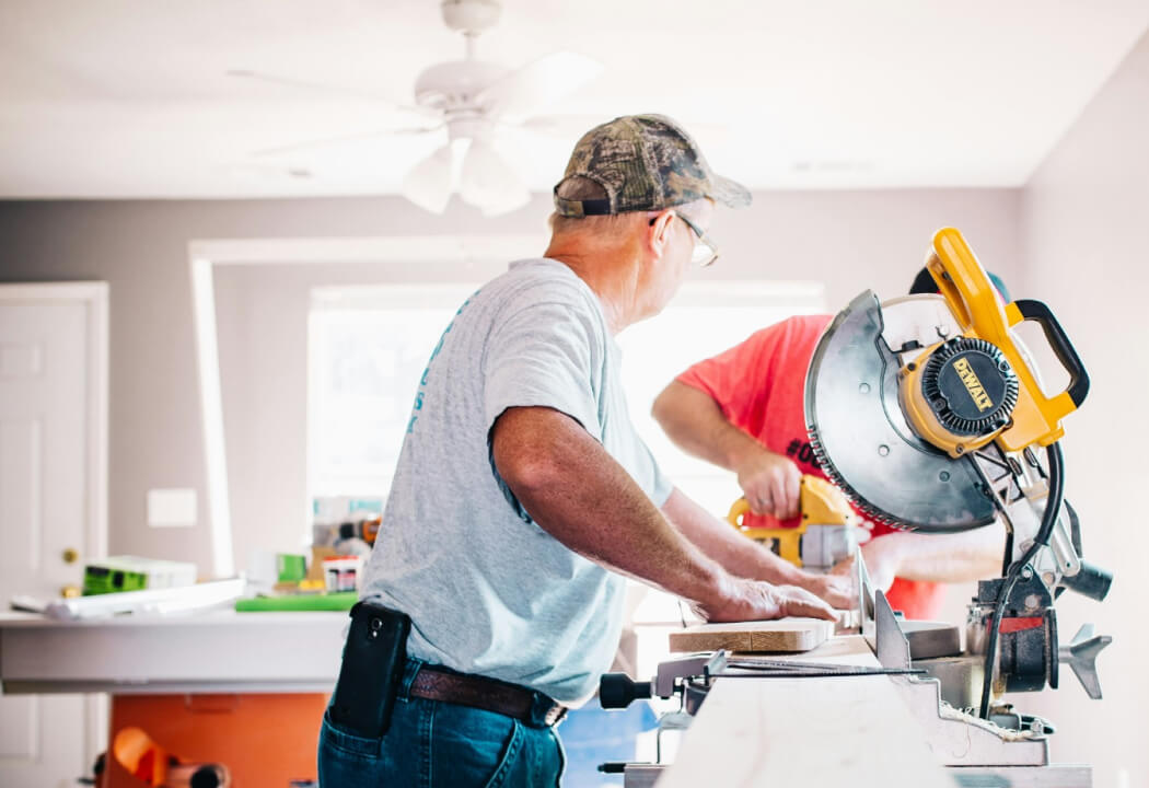 Older gentleman using a table saw