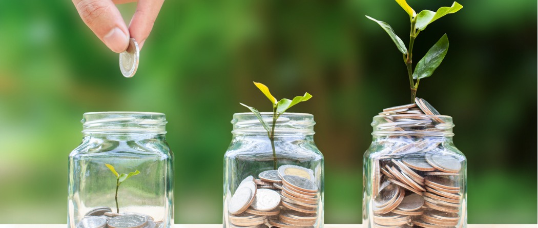 Jars of money showing the growth of saving